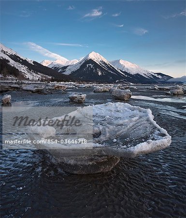 Stranded ice floes at low tide on the Turnagain Arm with alpenglow on the Chugach Mountains in the background, Southcentral Alaska, Winter