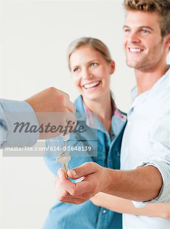 Young couple being handed house keys