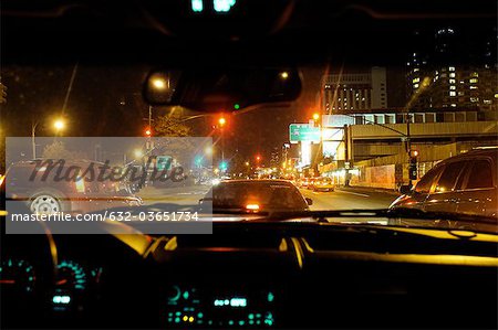Congested city street viewed from inside car at night