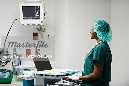 Nurse using computerized medical equipment