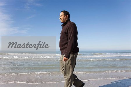 Mature man walking on beach