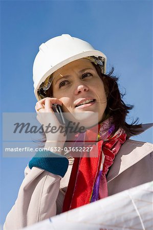 Female architect using cell phone, portrait