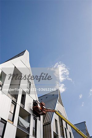 Cherry picker and incomplete building exterior