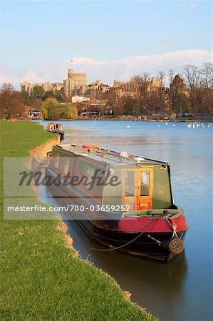 Barged Moored on the Bank of the River Thames, Windsor Castle in the Background, Windsor, Berkshire, England