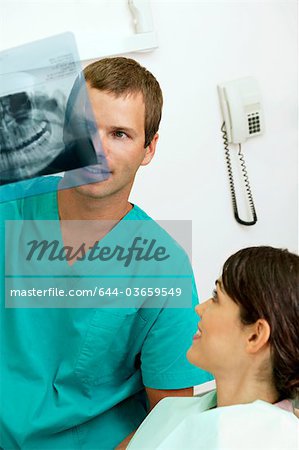 Patient with dentist holding dental panoramic xray
