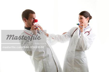 Male and female doctors with party toys