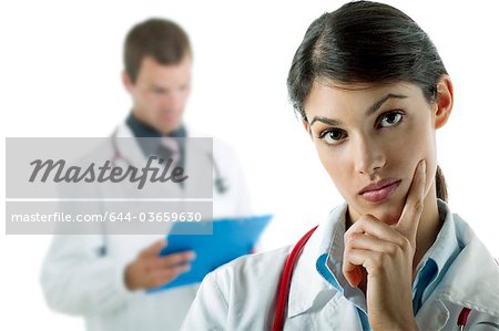 Doctor thinking and doctor reading medical chart