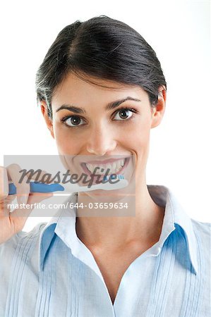 Young woman holding toothbrush