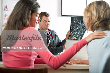 Woman consoling patient at doctor's visit