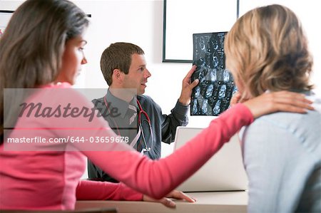 Woman consoling patient at doctor's visit