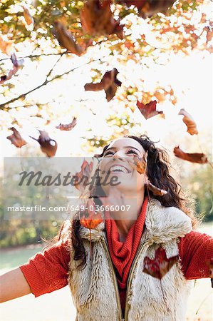 young woman playing with leaves