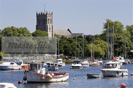 Christchurch Priory and pleasure boats on the River Stour, Dorset, England, United Kingdom, Europe