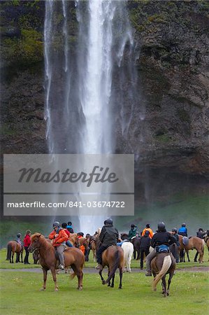 Horse riders taking a rest at Seljalandsfoss on the south coast of Iceland
