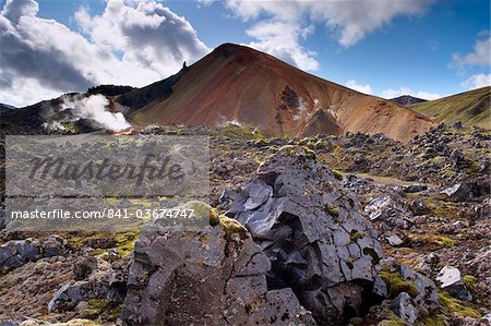 Brennisteinsalda, 855 m, Iceland's most colourful mountain, dominates the lava fields of Laugahraun, Landmannalaugar area, Fjallabak region, Iceland, Polar Regions