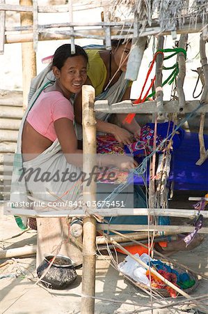 Assamese tribal village women spinning cotton at domestic loom, Majuli Island, Assam, India, Asia