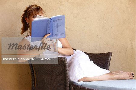 Woman reading the Bible, Abu Dhabi, United Arab Emirates, Middle East