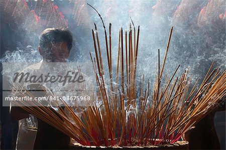 Burning incense during Tet, the Vietnamese lunar New Year celebration, Quan Am Pagoda, Ho Chi Minh City, Vietnam, Indochina, Southeast Asia, Asia
