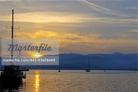 Sailing boat at sunset in the harbor of Nafplio, Peloponnese, Greece, Europe