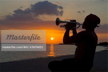 Trumpet player at sunset, Playa Ancon, Trinidad, Cuba, West Indies, Caribbean, Central America