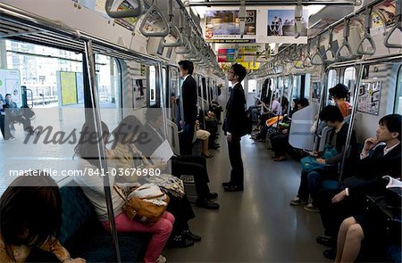 Passengers riding aboard the Yamanote loop line train that encircles greater metropolitan Tokyo, Japan, Asia