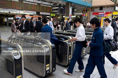 Passengers passing through automatic ticket wickets upon entering the JR Ueno railway station in Tokyo, Japan, Asia