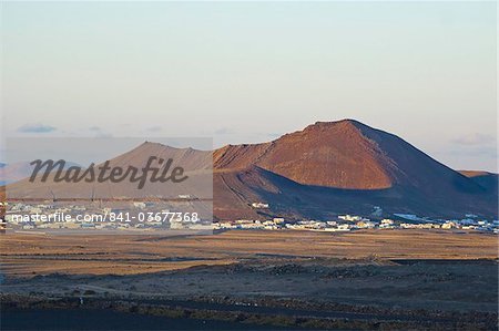 Volcanic cinder cones and the town of Soo at sunset in the mid north of the island, Soo, Lanzarote, Canary Islands, Spain, Atlantic Ocean, Europe