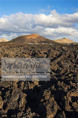 Irregular blocky lava (a'a) and cinder cones of the volcanic landscape of Timanfaya National Park, Lanzarote, Canary Islands, Spain, Atlantic Ocean, Europe Irregular blocky lava (a'a) and cinder cones of the volcanic landscape of Timanfaya National Park, Lanzarote, Canary Islands, Spain, Atlantic Ocean, Europe