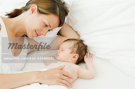 Mother watching baby sleep
