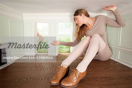 Young woman in small room being handed a key