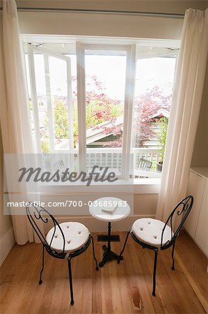 French Chairs and Small Marble Reading Table near Window