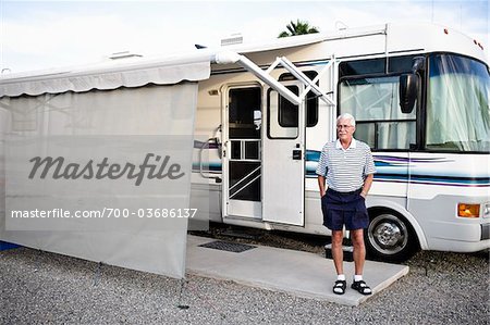 Man Standing in front RV in Trailer Park, Yuma, Arizona, USA