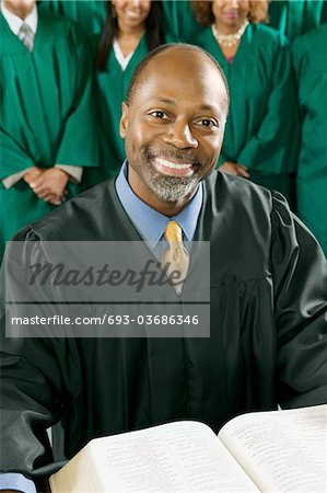 Smiling Preacher with Bible in church, portrait