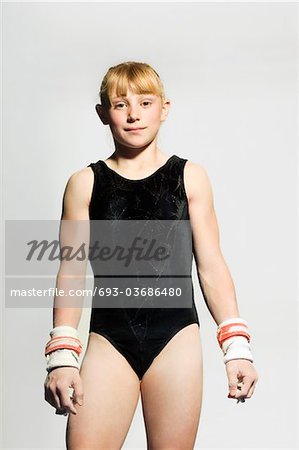 Gymnast (13-15) in leotard wearing palm guards, portrait