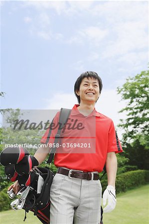 Man Carrying Golf Bag