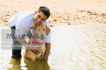 Man and golden retriever in the sea