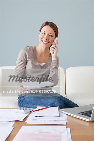 Young woman on the phone with laptop