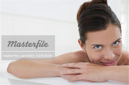 Woman relaxing in bathtub, close-up, portrait