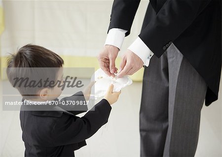 Boy holding out a ring pillow Boy holding out a ring pillow