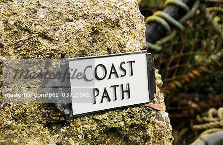 South West Coastal Path sign in Cadgwith Cove near The Lizard, Cornwall, UK South West Coastal Path sign in Cadgwith Cove near The Lizard, Cornwall, UK