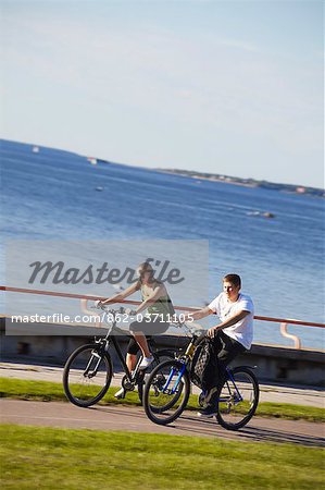 Estonia, Tallinn, Boy And Girl Cycling Along Pirita Tee