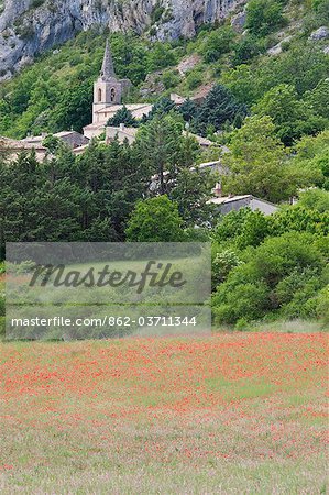 Provence, France. A french hill town in Provence with poppies in the foreground Provence, France. A french hill town in Provence with poppies in the foreground
