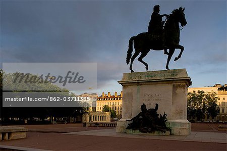 Lyon, France; Statue of Louis XIV and Basilique Notre Dame de Fourviere Place Bellecour Presqu ile