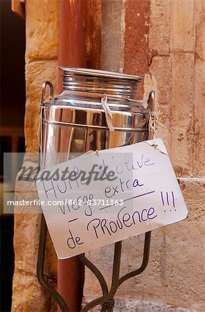 Rousillion; France. A hand made sign on a can of virgin olive oil for sale in Provence