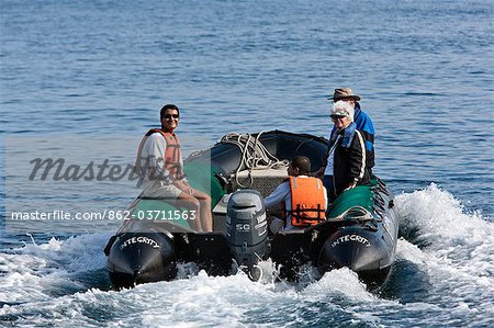 Galapagos Islands,   panga  or inflatable rubber dingy takes visitors back to the yacht from Genovese Island.