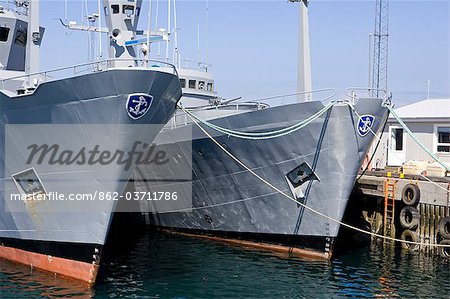 Iceland,Reykjavik. In the port area of Reykjavik,the country's capital,Icelandic navy patrol vessels are tied up alongside the jetty.