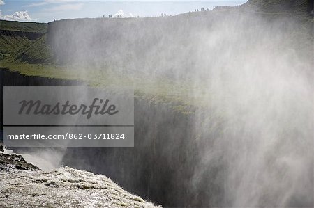 Iceland. Gullfoss (Golden Falls) is a magnificient 32m high double waterfall on the White River (Hvíta). The flow of the river from the regular rains and the glacial runoff,particularly in summer,makes it the largest volume falls in Europe.