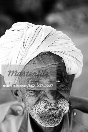 India,Rajasthan,Jaisalmer. Inside of Jaisalmer Fort,a stall holder in the market has a face that reflects his life struggle.