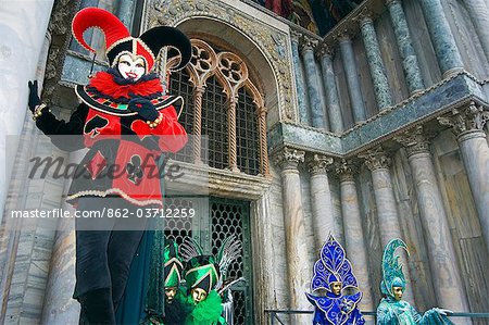 Venice Carnival Joker Costumes and Mask infront of St Marks Cathedral