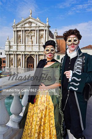 Venice Carnival People in Costumes and Masks Ponto San Geremia Church