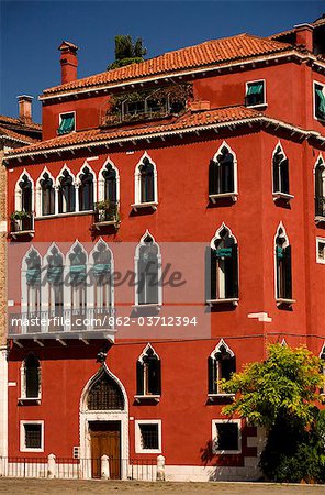 Italy, Veneto, Venice; One of the countless Venetian Palaces, brightly coloured, with typical Venetian Windows